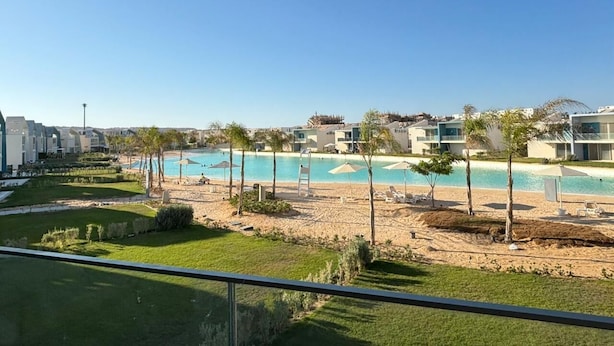 A resort with a pool, beach, and buildings with balconies. - Fouka North Coast CL9-CH22-01 (Marsa Matrouh)
