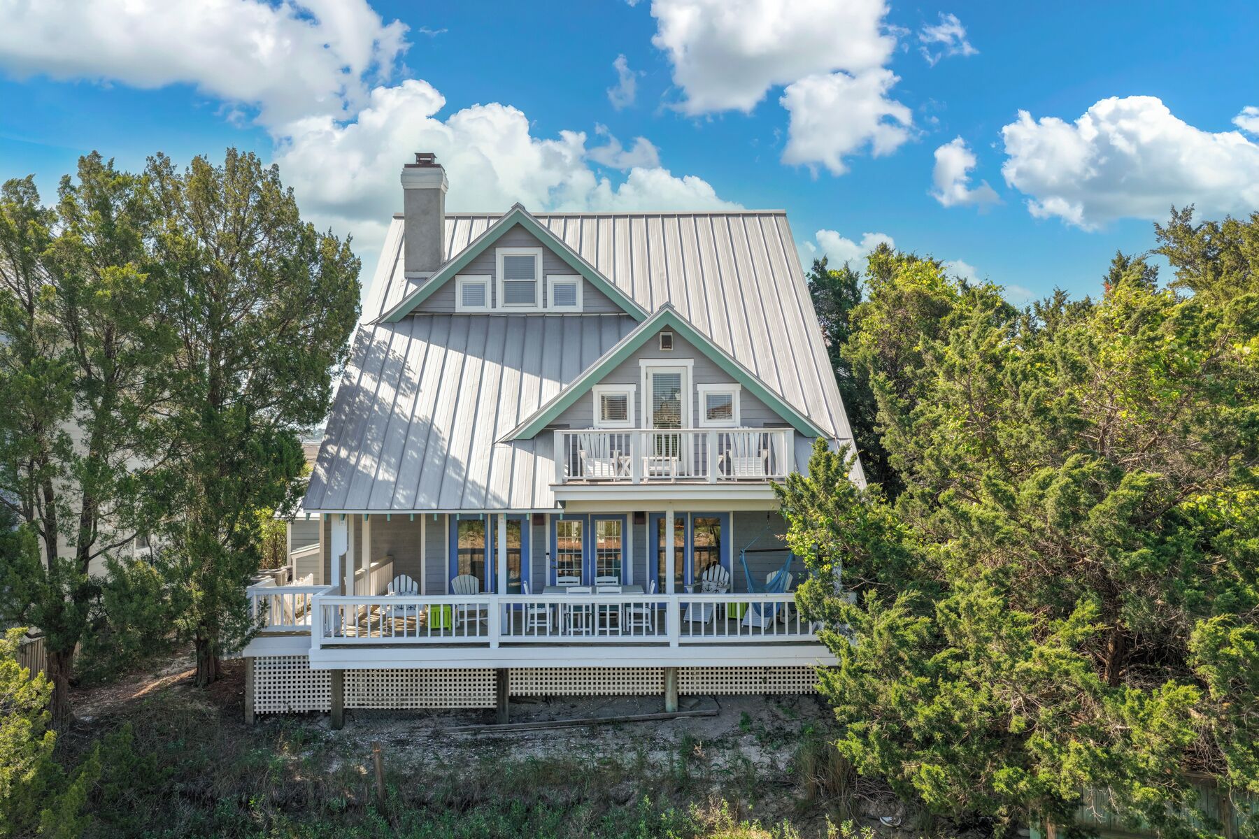 A two-story house with a balcony and a covered porch.
