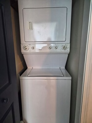 A compact, modern washing machine with multiple settings and a control panel.