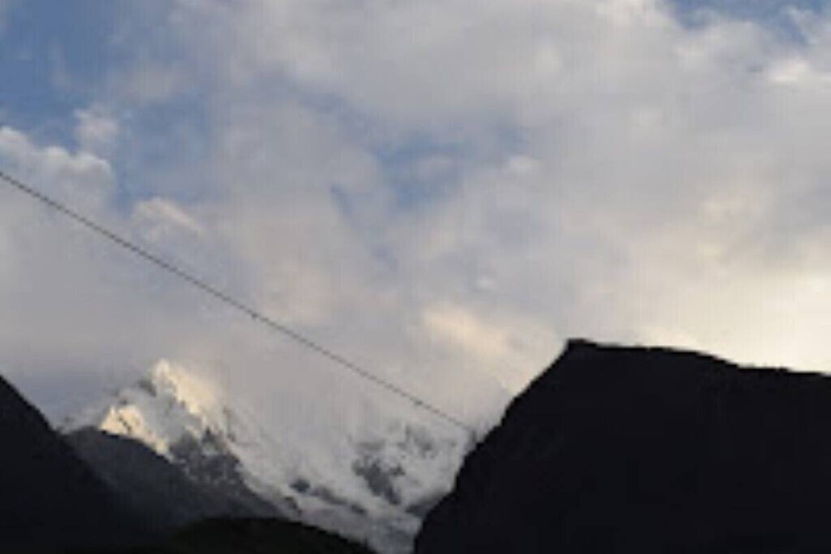 A mountain landscape with a power line.