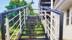A metal staircase with handrails leading to a building entrance. - Anava Farms (Shrirangapattana)