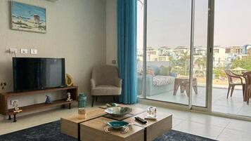Chalet, 2 Bedrooms, Lagoon View | Living area | Flat-screen TV