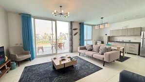 A modern living room with a sofa, coffee table, and TV. - Fouka North Coast CL5-TW1-BF (Marsa Matrouh)