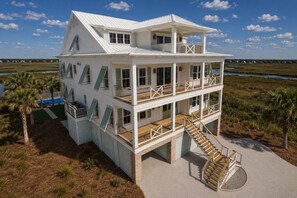 A multi-story coastal house with a balcony, a pool, and a staircase leading to the entrance. - Second To None: Brand-New Luxury Retreat with Ocean Views, Pool & Hot Tub (Murrells Inlet)