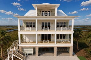 A multi-story beachfront house with a balcony, a covered porch, and a view of the beach. - Second To None: Brand-New Luxury Retreat with Ocean Views, Pool & Hot Tub (Murrells Inlet)