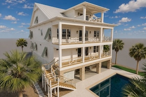 A multi-story beachfront property with balconies, a swimming pool, and palm trees. - Second To None: Brand-New Luxury Retreat with Ocean Views, Pool & Hot Tub (Murrells Inlet)