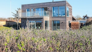 A modern two-story house with large windows, a balcony, and a well-maintained garden. - 5 Star Holiday Home in Vejby (Vejby)