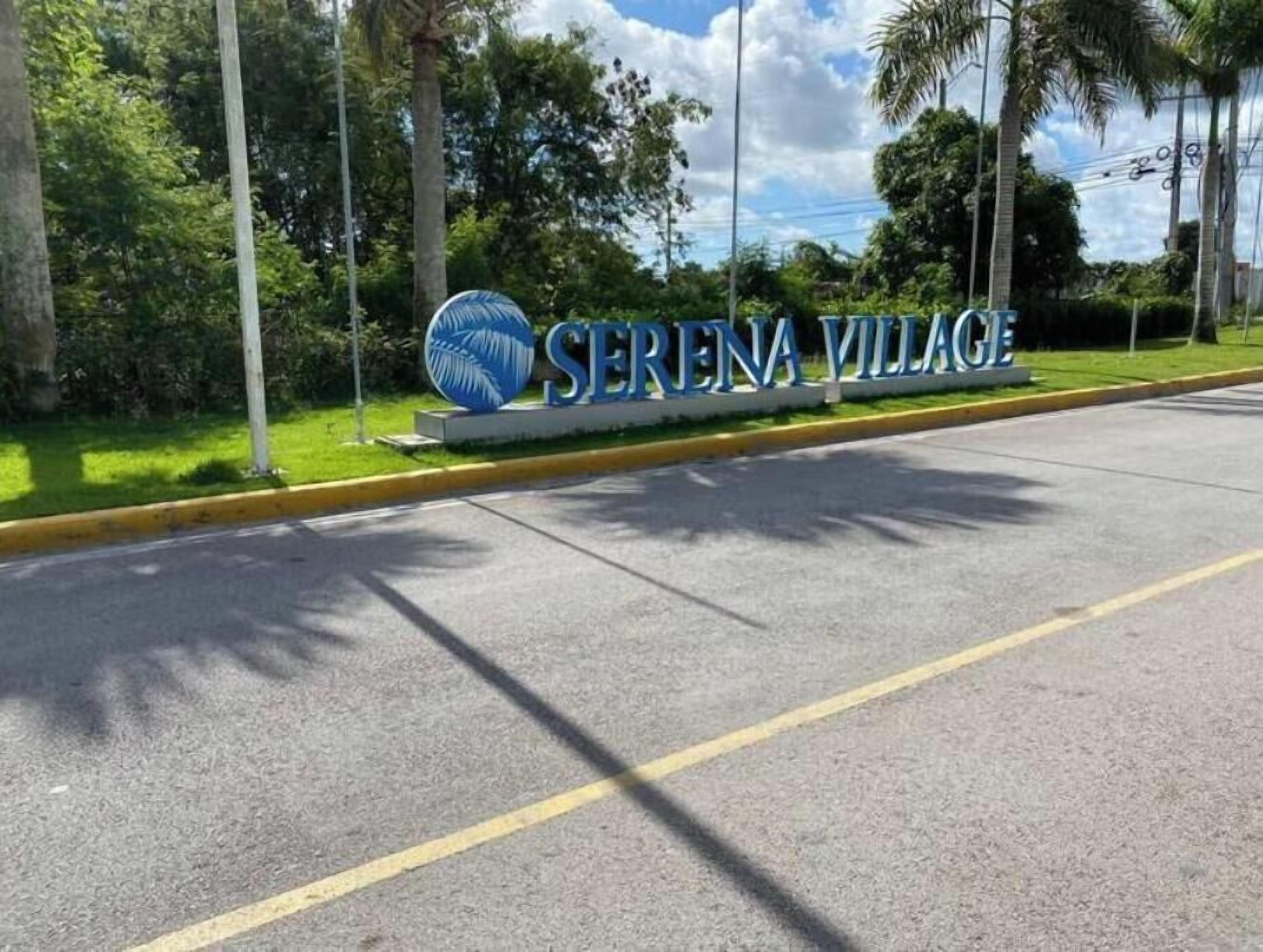 A road sign with 'SERENA VILLAGE' and a palm tree.