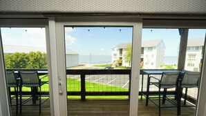 Ein Balkon mit Meerblick, einem Tisch und Stühlen.