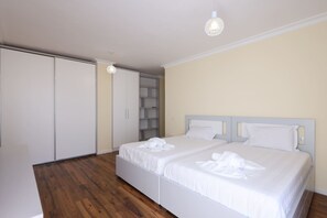 A bedroom with a double bed, a wardrobe, and a built-in shelving unit. - Panoramic Sea-View Apartment, Durrës Promenade (Durrës)