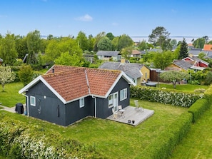 Een woonwijk met huizen, een gazon en een heldere lucht.