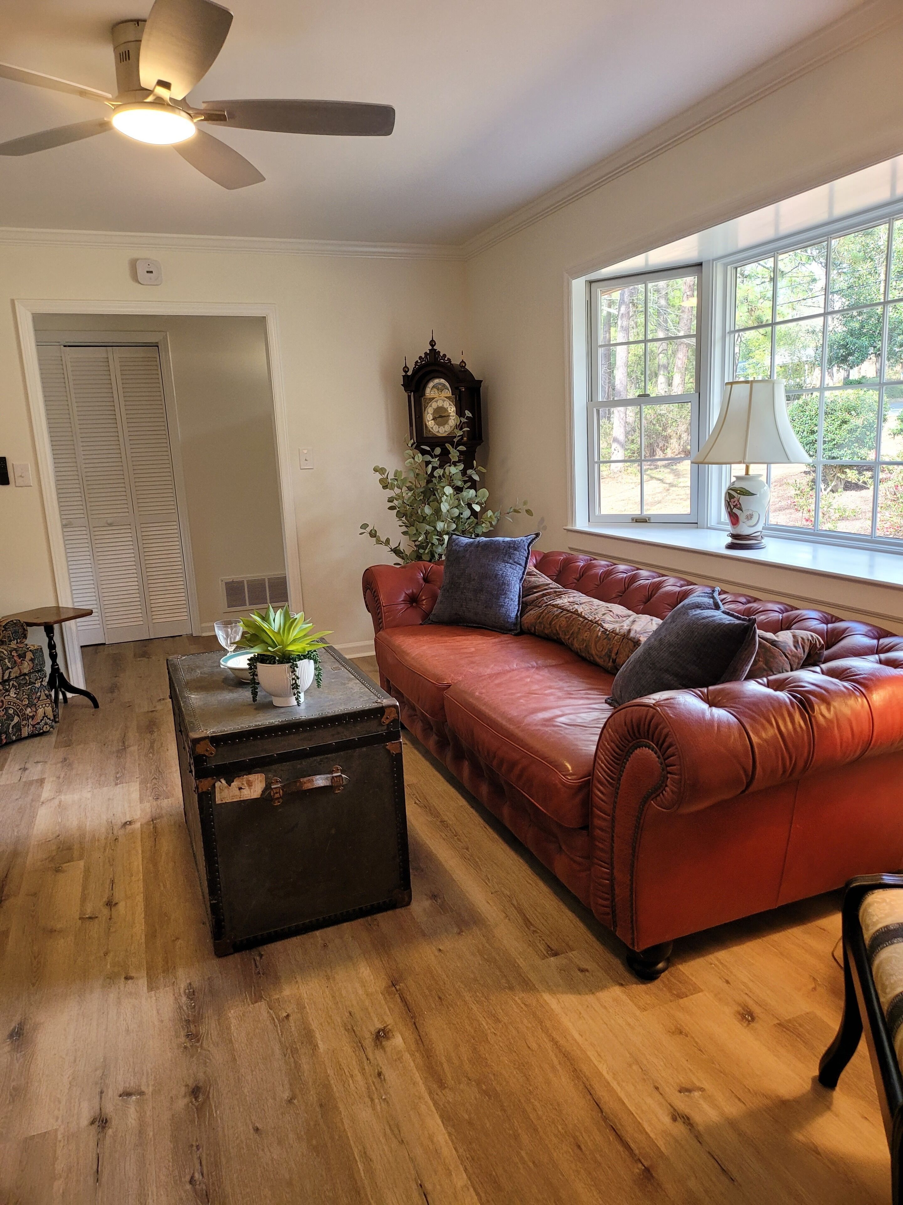 Bright, cozy living room with leather seating and charming classic details