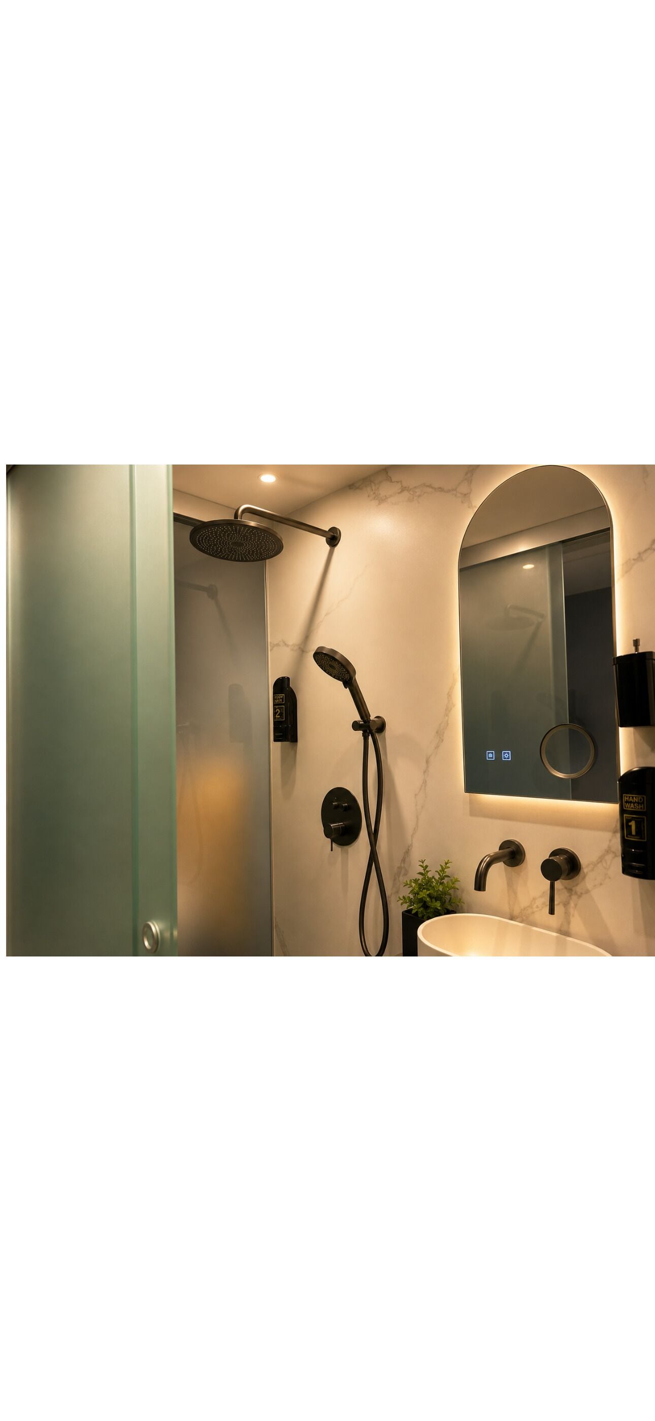 Un baño moderno con ducha, lavamanos, espejo y pantalla digital.