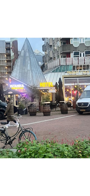 A hotel with a modern design, outdoor seating, and a prominent sign. - The Hyve Budget Hotel Rotterdam (Rotterdam)
