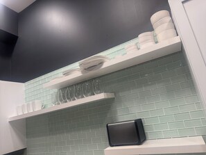 A kitchen with white shelves, a toaster, and a tiled backsplash. - Modern St. Louis Retreat – Near Downtown & Soulard (St. Louis)