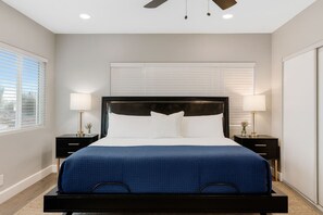 A bedroom with a large bed, two bedside tables, a ceiling fan, and a window with blinds. - Two-Private Units/Sleep 9/Pool&Spa/Parking/AC (San Diego)