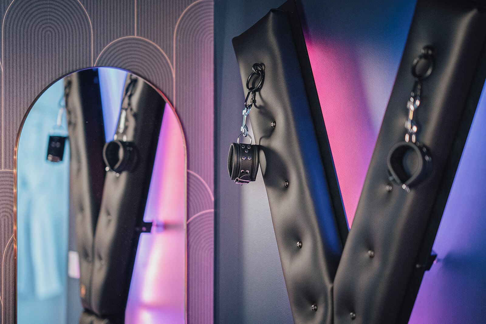 A close-up of a black leather chair with a metal ring and a keychain attached to it.