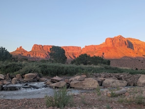 A river flowing through a rocky landscape with a mountain in the background.