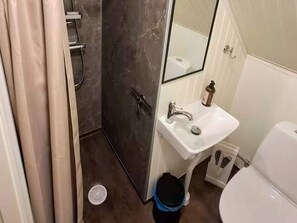A bathroom with a shower, sink, and toilet. - 5 Star Holiday Home in Skattungbyn Orsa (Orsa)