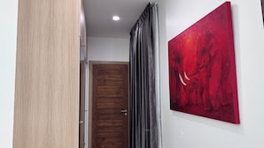 A hallway with a wooden door, a painting, and a curtain. - Luxury 3-bedroom Pool Villa in peaceful Hua Hin (Hua Hin)