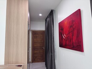 A hallway with a wooden door, a painting, and a curtain. - Luxury 3-bedroom Pool Villa in peaceful Hua Hin (Hua Hin)