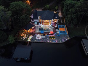 An aerial view of a house with a swimming pool, outdoor seating, and a basketball court. - The Superstar | Waterfront Pool & Pickleball (Hot Springs National Park)