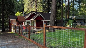 A fenced campground with cabins and a covered picnic area. - Cozy 1-bedroom cabin in soothing Pollock Pines with AC (Pollock Pines)