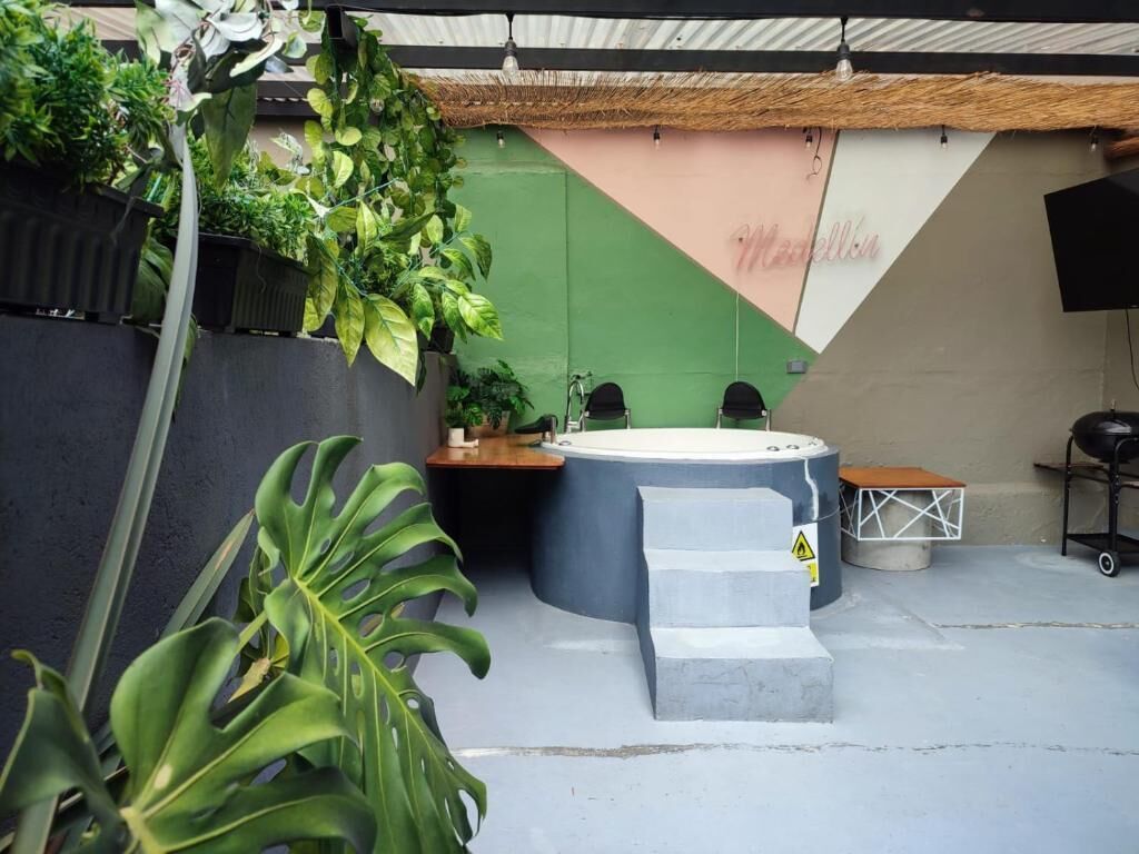Ein Whirlpool, eine Treppe und eine Wand mit Grün- und Beigetönen.