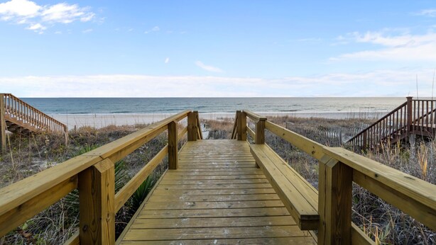 A wooden boardwalk leading to a beach with a clear view of the ocean. - Salt Life | Deck Views + Steps to Beach, Sleeps 10 (North Topsail Beach)