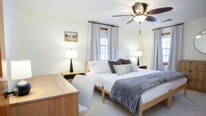 A bedroom with a bed, bedside tables, a desk, a ceiling fan, and a mirror. - Farmington gem near UConn Health with garage • Fast Wi-Fi • Dog Friendly (Farmington)