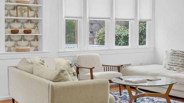 A living room with a sofa, armchairs, a glass coffee table, and a shelving unit with decorative items. - Charming & Peaceful Catskills Getaway 2hr from NYC (Mountain Dale)