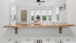 A kitchen with a wooden countertop, a ceiling fan, a wine bottle, and a window with a view of greenery. - Charming & Peaceful Catskills Getaway 2hr from NYC (Mountain Dale)