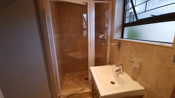Deluxe Quadruple Room, Patio, Garden View | Bathroom | Combined shower/bathtub, towels, soap, shampoo