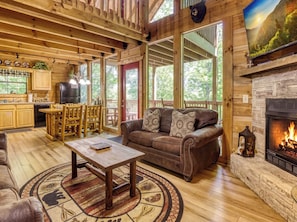 A wooden cabin interior with a living room, kitchen, and dining area. - Bear-rif-ic Cabin w/ Hot Tub & Pool Table (Sevierville)