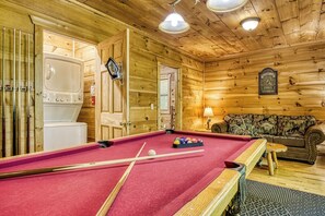 A wooden interior with a pool table, a sofa, and a fireplace. - Mountain Views & Hot Tub | Near Dollywood (Sevierville)