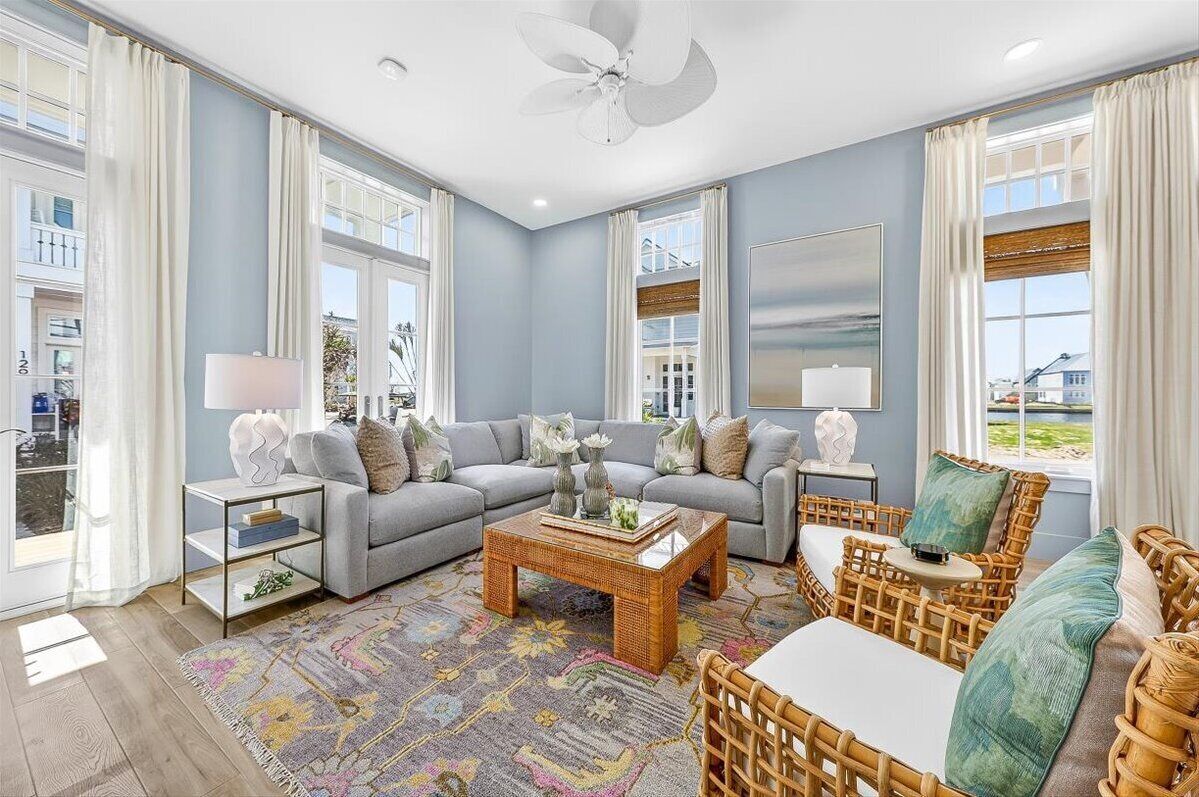 A modern living room with a sofa set, a coffee table, and a wicker chair.