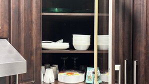 A kitchen with dark wooden cabinets, a marble countertop, a blender, a toaster, and a framed certificate. - Peaceful Family Home | 4BR, Huge Deck, Garage & Free Wi-Fi (Winnipeg)