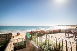 A coastal view with a paved terrace, outdoor seating, and a stone wall. - Sahara Park (No 11) | Elie (Elie)