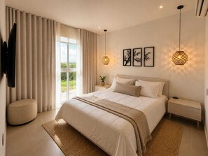 Un dormitorio con una cama grande, un televisor instalado en la pared, una ventana con cortinas y una lámpara fijada en la pared.
