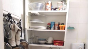 A compact kitchen with a stove, sink, and various utensils. - Small Cosy Studio near City, Aldgate East (London)