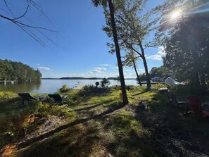 A lakeside setting with a dock, chairs, and a tent. - Lake Rosseau Escape, 3 Bedroom, New Reno, Hot Tub! (Minett)