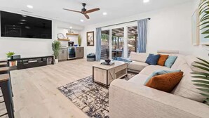 A modern living room with a sofa, coffee table, and TV.