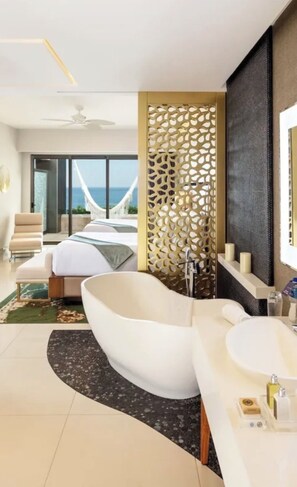 A modern bathroom with a freestanding bathtub, a large mirror, and a shower area.