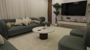 Appartement, 2 chambres | Coin séjour | Télévision à écran plat de 32 pouces avec chaînes par satellite