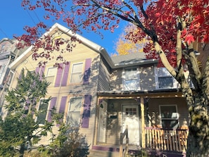 A two-story house with a front porch, a mailbox, and a door number 106. - The Quaint House: Modern Heritage in Roundout Kingston Waterfront (Kingston)