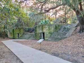 A historical building with stone steps and a signboard.