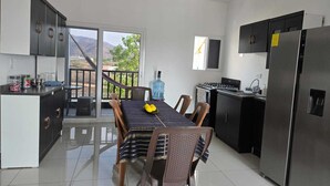 Una cucina moderna con zona pranzo, un distributore d'acqua di grandi dimensioni e vista sull'esterno.