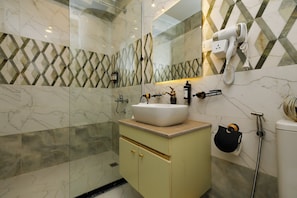 A bathroom with a sink, mirror, towel rack, and a hairdryer on the wall. - Pyramids Palace View (Giza)