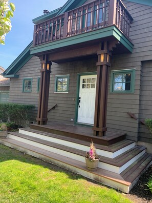 A two-story house with a balcony, a front door, and a small porch. - 4 miles from Shinnecock Hills US Open - on the water newly renovated (Hampton Bays)