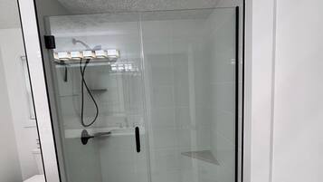 Shower, hair dryer, towels, toilet paper